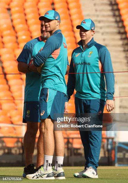 Peter Handscomb and Steve Smith of Australia inspect the pitch during an Australia Test squad training session at Narendra Modi Stadium on March 07,...