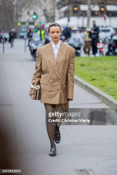 Nataly Osmann wears beige oversized blazer, skirt, bag outside Stella McCartney during Paris Fashion Week - Womenswear Fall Winter 2023 2024 : Day...