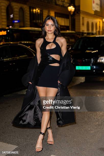 Kelsey Merritt wears black two tone cut out dress, black coat outside Dundas during Paris Fashion Week - Womenswear Fall Winter 2023 2024 : Day Eight...