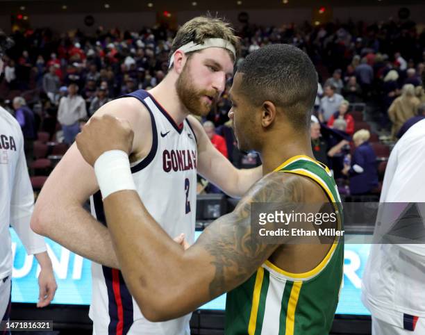 Drew Timme of the Gonzaga Bulldogs and Khalil Shabazz of the San Francisco Dons embrace after a semifinal game of the West Coast Conference...