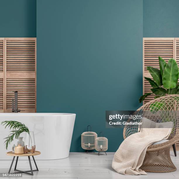 cozy retro-chic interior with an art deco rattan rounded wicker armchair, bathtub and potted plants, 50s- 60s decoration - teal stock pictures, royalty-free photos & images
