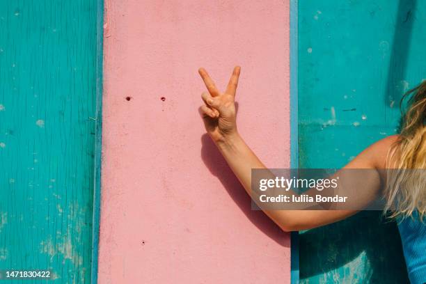 woman's hand showing peace sign - cnd sign stock pictures, royalty-free photos & images