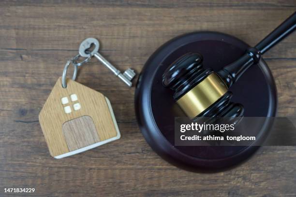 garvel and house's key on wood background. - bankruptcy law stock pictures, royalty-free photos & images