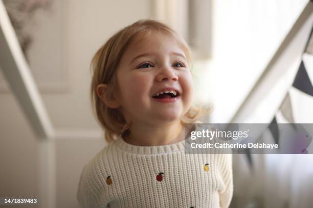 portrait of a 3 year old girl smiling, at home - 2 year old child imagens e fotografias de stock