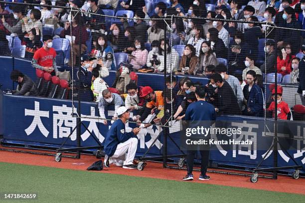 Outfielder Lars Nootbaar of Japan signs autographs for fans prior to the World Baseball Classic exhibition game between Japan and Orix Buffaloes at...