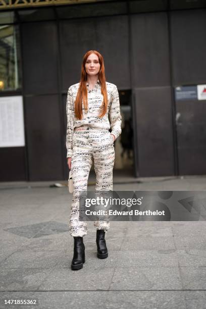 Sophie Turner wears a white with black musical notes print pattern shirt, matching white with black musical notes large pants, a beige Epi leather...