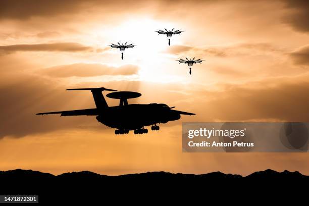 drone attack on airborne early warning and control aircraft in the sky - industria della difesa foto e immagini stock