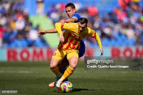 Angel Algobia of Getafe CF battle for the ball with Borja Garcia of Girona FC during the LaLiga Santander match between Getafe CF and Girona FC at...