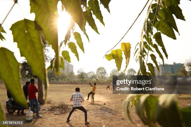 Locals gather after work to play cricket on March 07, 2023 in Ahmedabad, India.