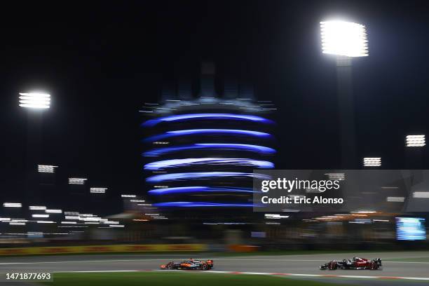 Oscar Piastri of Australia driving the McLaren F1 Team MCL60 and Zhou Guanyu of China driving the Alfa Romeo F1 C43 Ferrari on track during the F1...