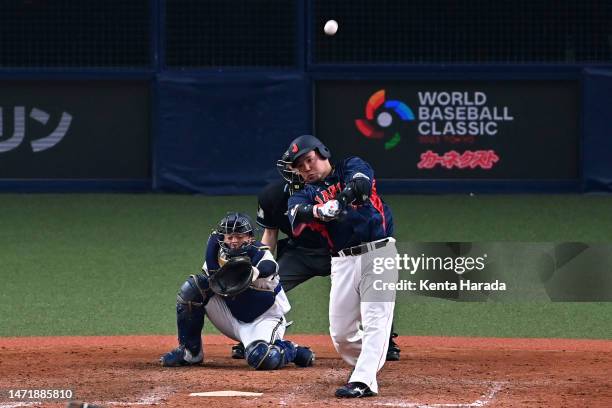 Infielder Hotaka Yamakawa of Japan hits a solo home run in the eighth inning during the World Baseball Classic exhibition game between Japan and Orix...