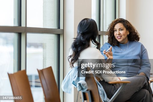 Unrecognizable female client listens as female counselor gives advice Unrecognizable female client listens as female counselor gives advice