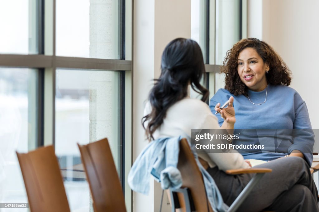 Unrecognizable female client listens as female counselor gives advice