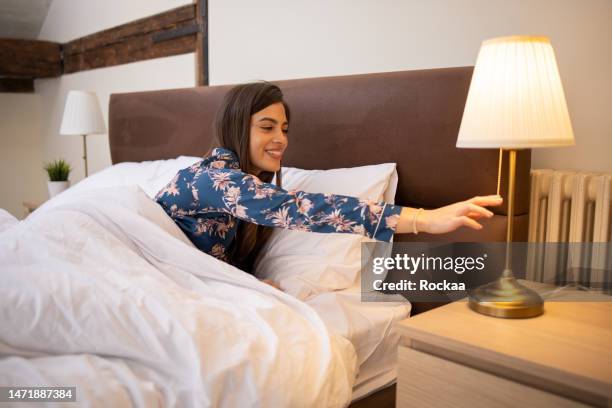young woman is getting ready for bed - good night imagens e fotografias de stock