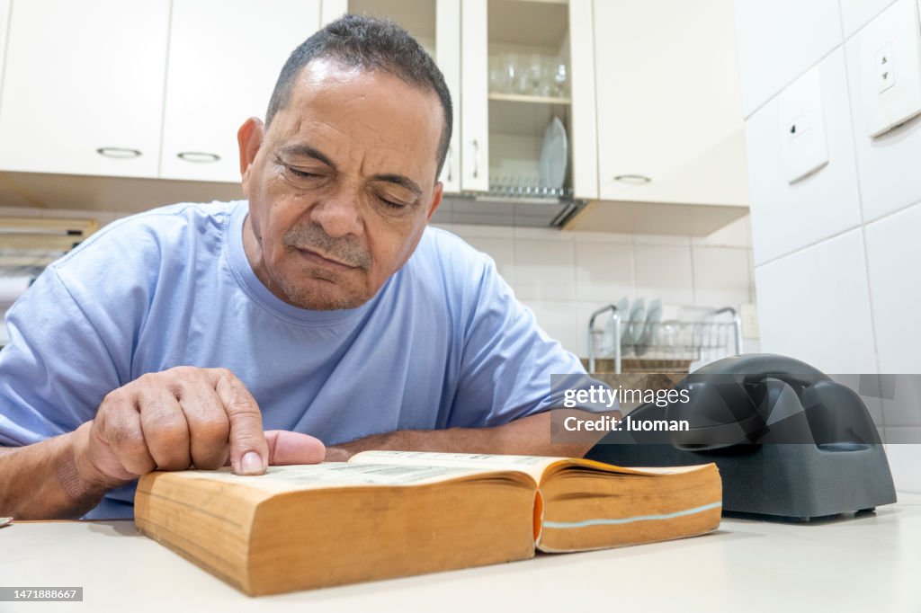 1970s: Man Uses the Yellow Pages to Find a Phone Number