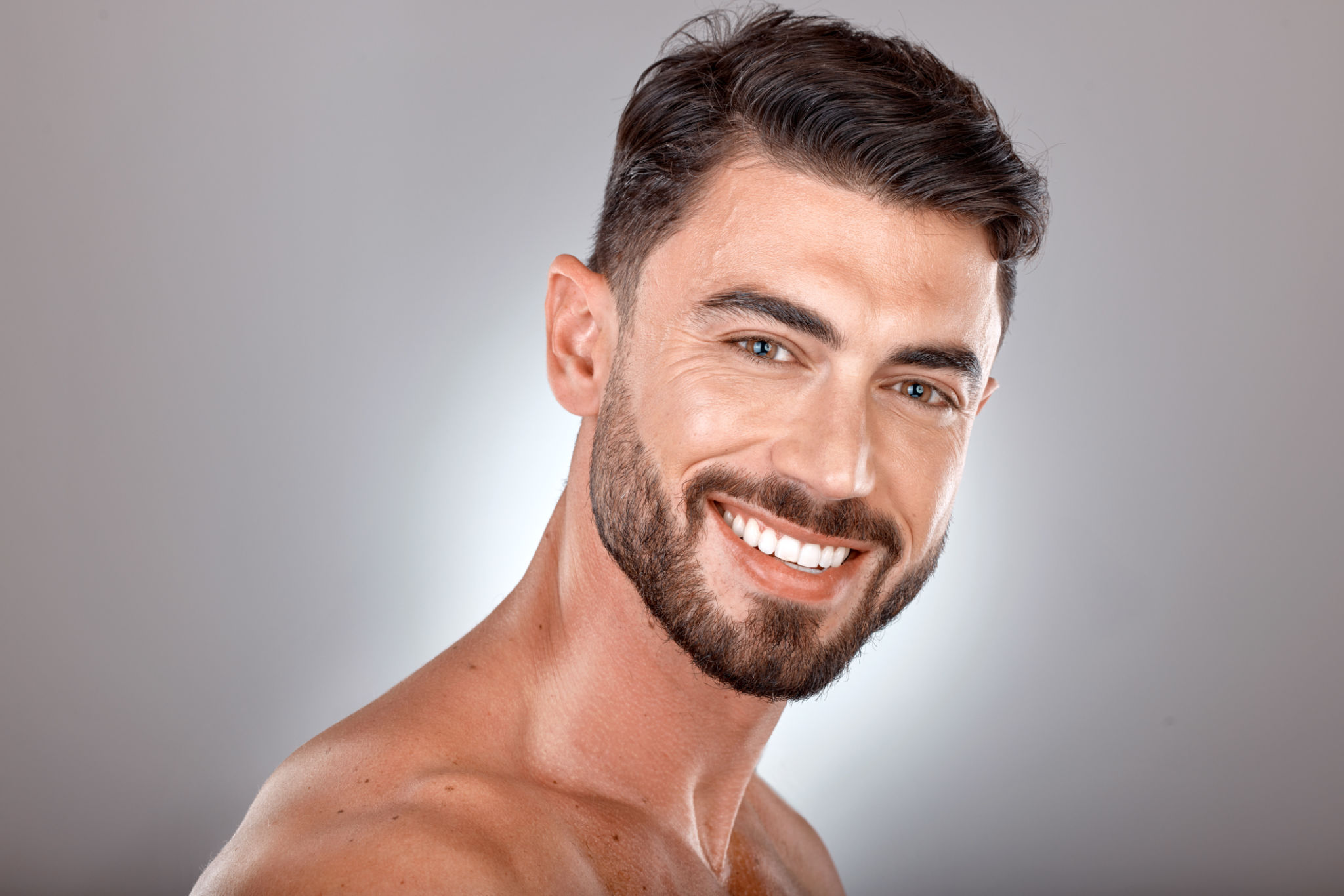 Beauty, skincare and portrait of man with smile on gray background studio for wellness, healthcare and hygiene. Cosmetics, grooming and face of male model for dentistry, body care and spa treatment Beauty, skincare and portrait of man with smile on gray background studio for wellness, healthcare and hygiene. Cosmetics, grooming and face of male model for dentistry, body care and spa treatment