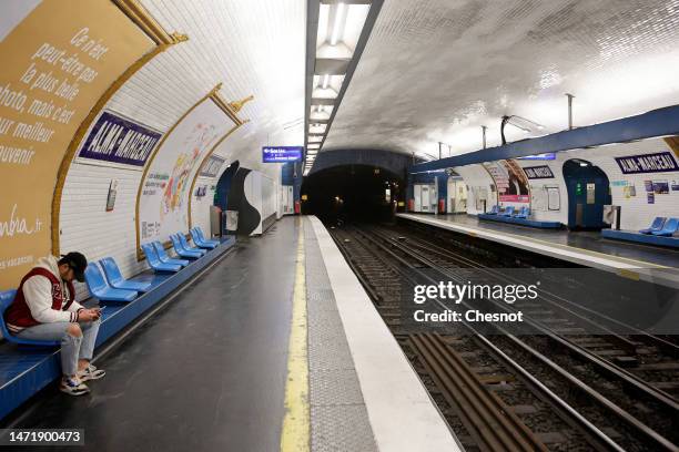 Man waits a subway on a deserted subway platform amid a disruption in train services during a new day of nationwide strike led by French trade unions...