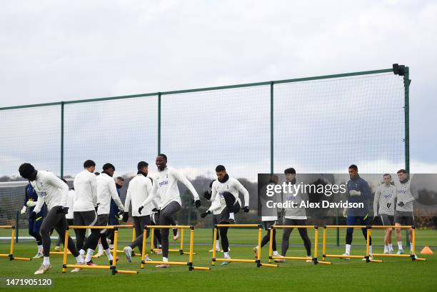 Players of Tottenham Hotspur warm up during a Tottenham Hotspur training session ahead of their UEFA Champions League round of 16 match against AC...