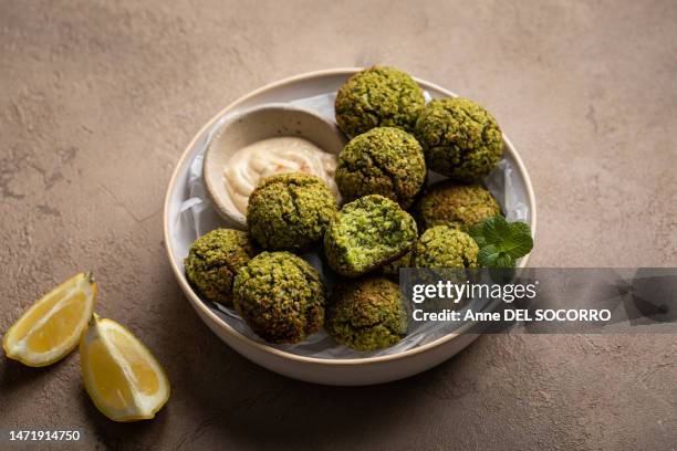 split peas falafels with parsley and tahini sauce - falafel stock pictures, royalty-free photos & images