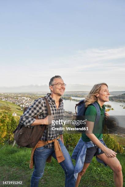 tourists walking on hill under sky - rheingau stock pictures, royalty-free photos & images
