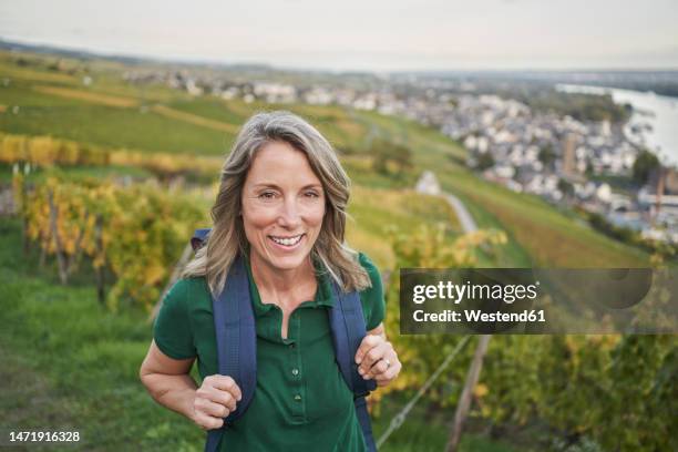 happy woman with backpack on hill - hessen deutschland stock-fotos und bilder