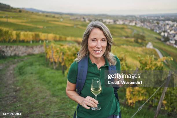 happy woman holding wineglass on hill - rheingau stock pictures, royalty-free photos & images