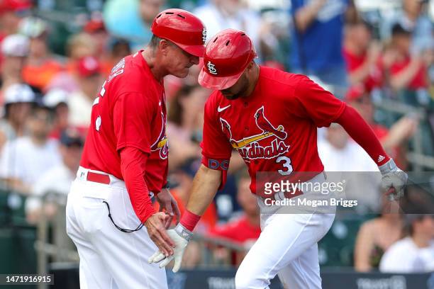 Dylan Carlson of the St. Louis Cardinals high fives Ron 'Pop' Warner of the St. Louis Cardinals after hitting a home run against the Houston Astros...
