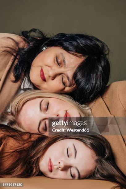teenage girl with woman and mother leaning head on each other - generation gap stock pictures, royalty-free photos & images