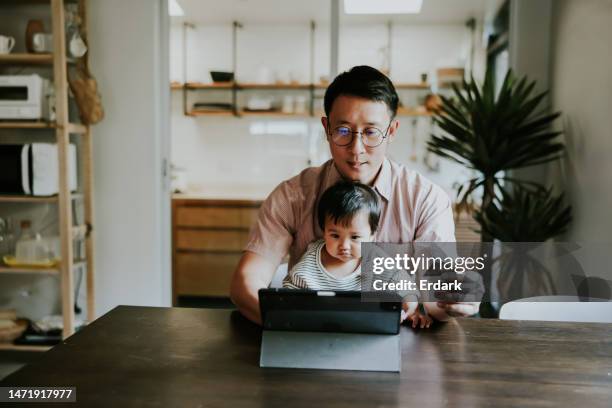 asian single father paying on online store with credit card. - asian credit card imagens e fotografias de stock