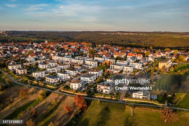 germany, baden-wurttemberg, baltmannsweiler, aerial view of modern suburb at autumn dusk - baden baden aerial fotografías e imágenes de stock