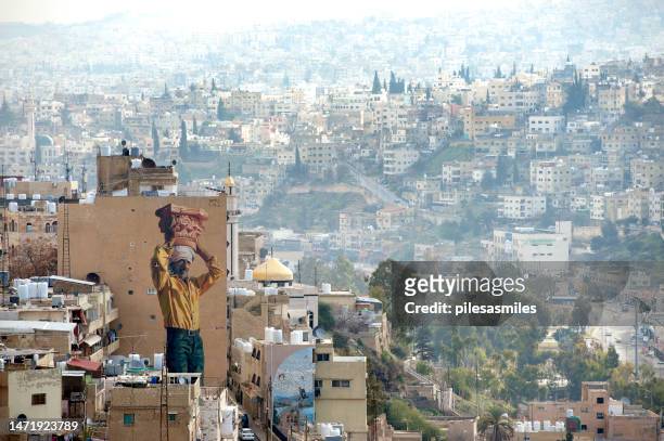 amman cityscape from jabal al-qala’a hill with huge wall murals, amman, jordan - jordanian stock pictures, royalty-free photos & images