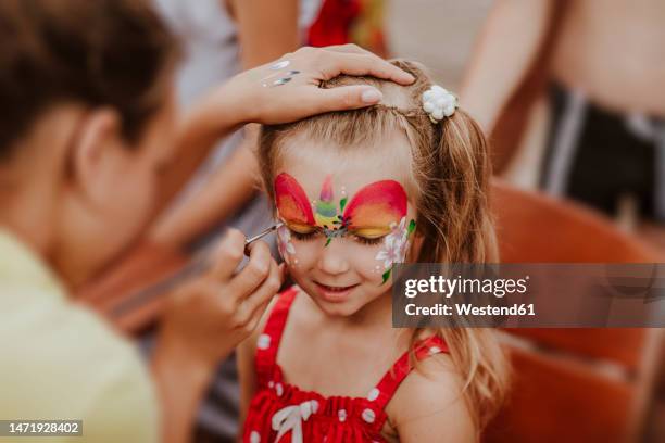 artist painting on girl's face - ansiktsmålning bildbanksfoton och bilder