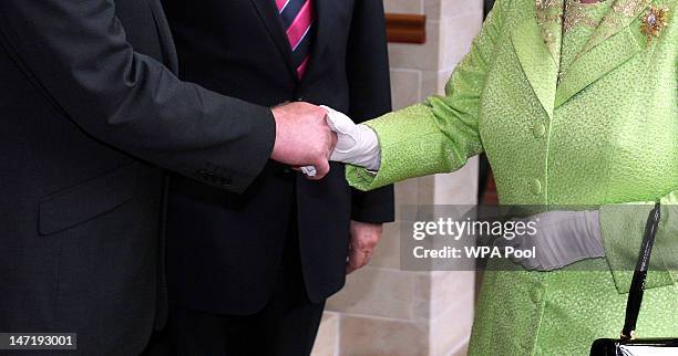 Queen Elizabeth II shakes hands with Deputy First Minister of Northern Ireland Martin McGuinness at the Lyric Theatre on June 27, 2012 in Belfast,...