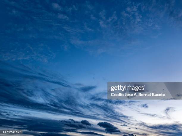 full frame, evening sky with some high clouds during the blue hour. - dark sky stock pictures, royalty-free photos & images