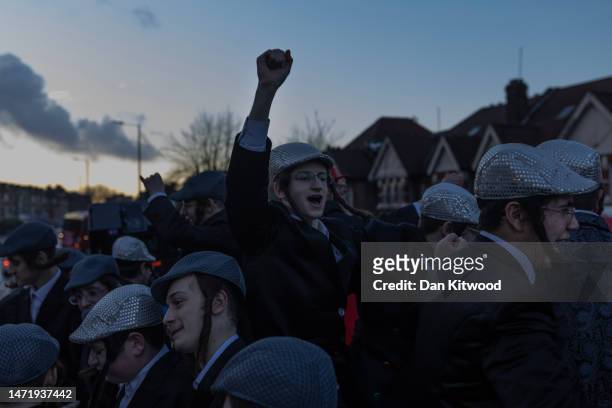 Group of Jewish boys dance on the top of an open top bus during Purim on March 07, 2023 in London, England. The annual Purim holiday is celebrated by...