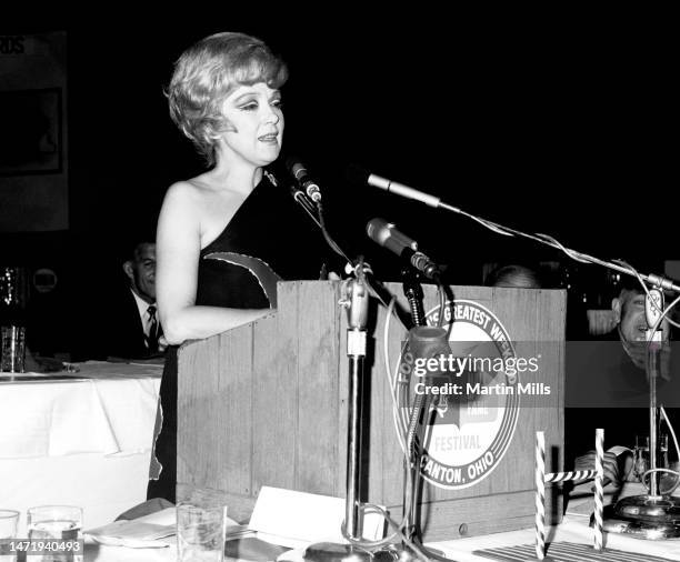 American comedienne, actress, singer and businesswoman Edie Adams speaks at the podium during the NFL Hall Of Fame Weekend dinner in Canton, Ohio,...