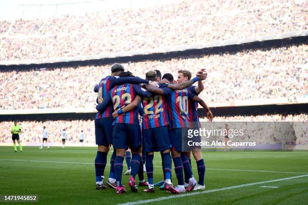 Barcelona players celebrate their team's first goal scored by Raphinha during the LaLiga Santander match between FC Barcelona and Valencia CF at...