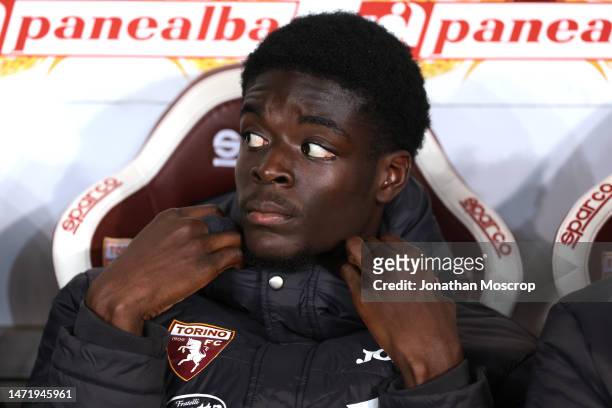 Ange N'Guessan of Torino FC looks on from the bench prior to kick off in the Serie A match between Torino FC and Bologna FC at Stadio Olimpico di...