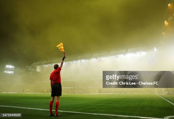 General view as a linesman raises their flag, as the stadium is filled with yellow smoke after fans of Borussia Dortmund use smoke flares, during the...