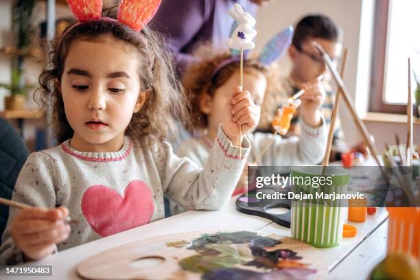 multi-generation family preparing decoration for easter holiday together at home - happy easter stock pictures, royalty-free photos & images