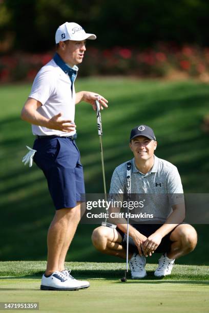 Justin Thomas of the United States and Jordan Spieth of the United States talk during a practice round prior to THE PLAYERS Championship on THE...