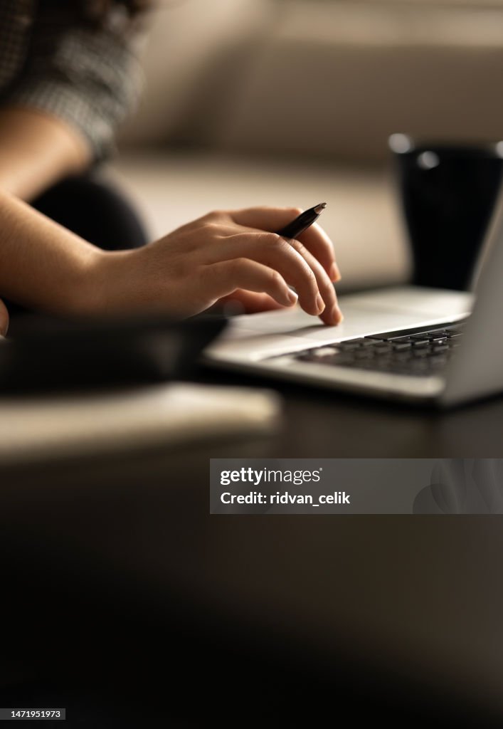 Closeup cropped image student girl hands typing using laptop