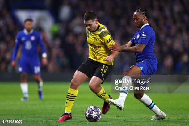 Raphael Guerreiro of Borussia Dortmund controls the ball whilst under pressure from Raheem Sterling of Chelsea during the UEFA Champions League round...