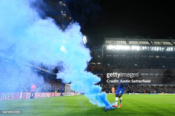 General view as Kalidou Koulibaly of Chelsea kicks a blue smoke flare off the pitch during the UEFA Champions League round of 16 leg two match...