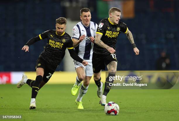 Jed Wallace of West Bromwich Albion battles for possession with Joe Bennett and James McClean of Wigan Athletic during the Sky Bet Championship...