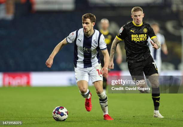 Jayson Molumby of West Bromwich Albion is put under pressure by James McClean of Wigan Athletic during the Sky Bet Championship between West Bromwich...