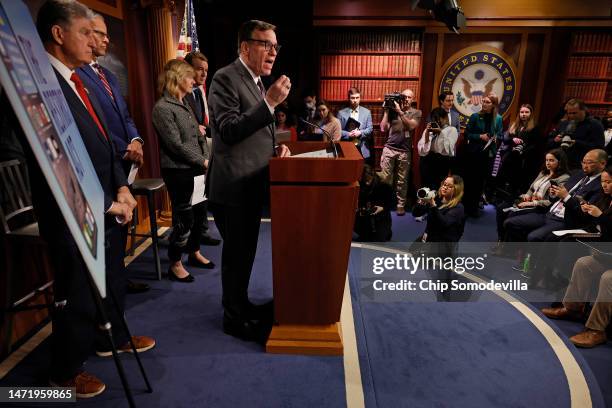 Senate Select Committee on Intelligence Chairman Mark Warner talks to reporters with Sen. Joe Manchin , Senate Minority Whip John Thune and other...