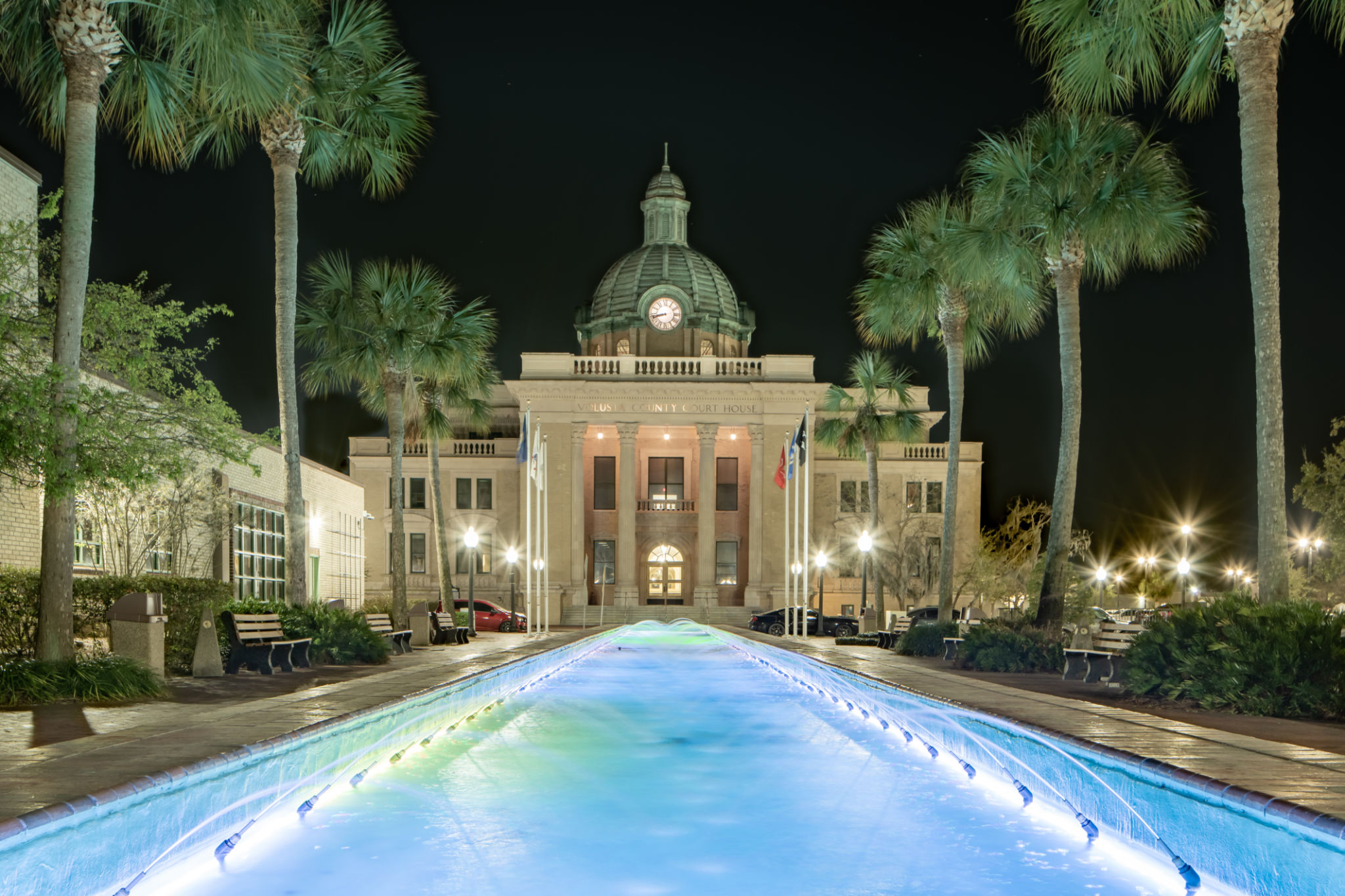 Evening photo of the historic Volusia County Courthouse and fountain pool in DeLand, Florida. Evening photo of the historic Volusia County Courthouse and fountain pool in DeLand, Florida.
