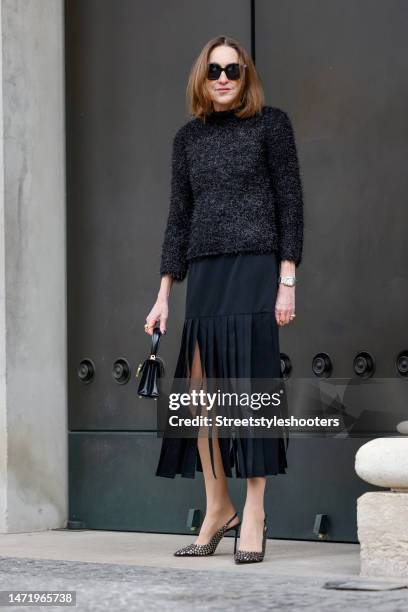 Influencer and style icon Annette Weber, wearing a black lame pullover by Tory Burch, a black skirt with long fringes by Tory Burch, a black bag by...