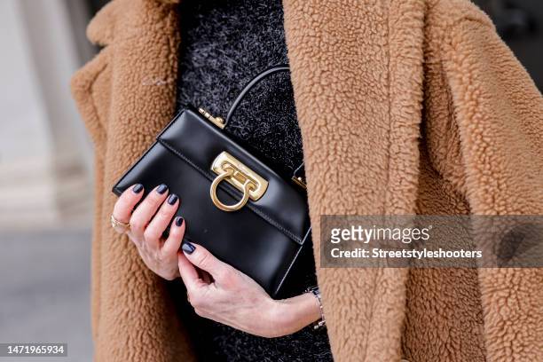 Influencer and style icon Annette Weber, wearing a black bag by Salvatore Ferragamo, during a streetstyle shooting on March 07, 2023 in Munich,...